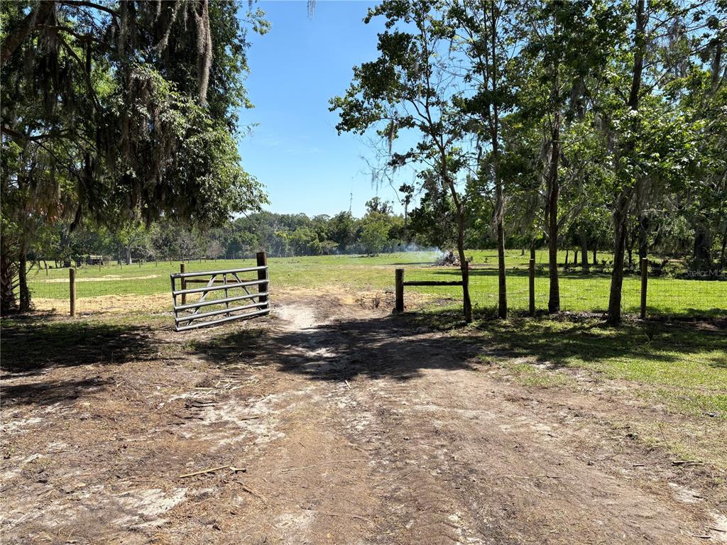 2110 Northwest 100th Street Ocala, FL 34475 - Photo 13 of 44 a view of a yard with wooden fence