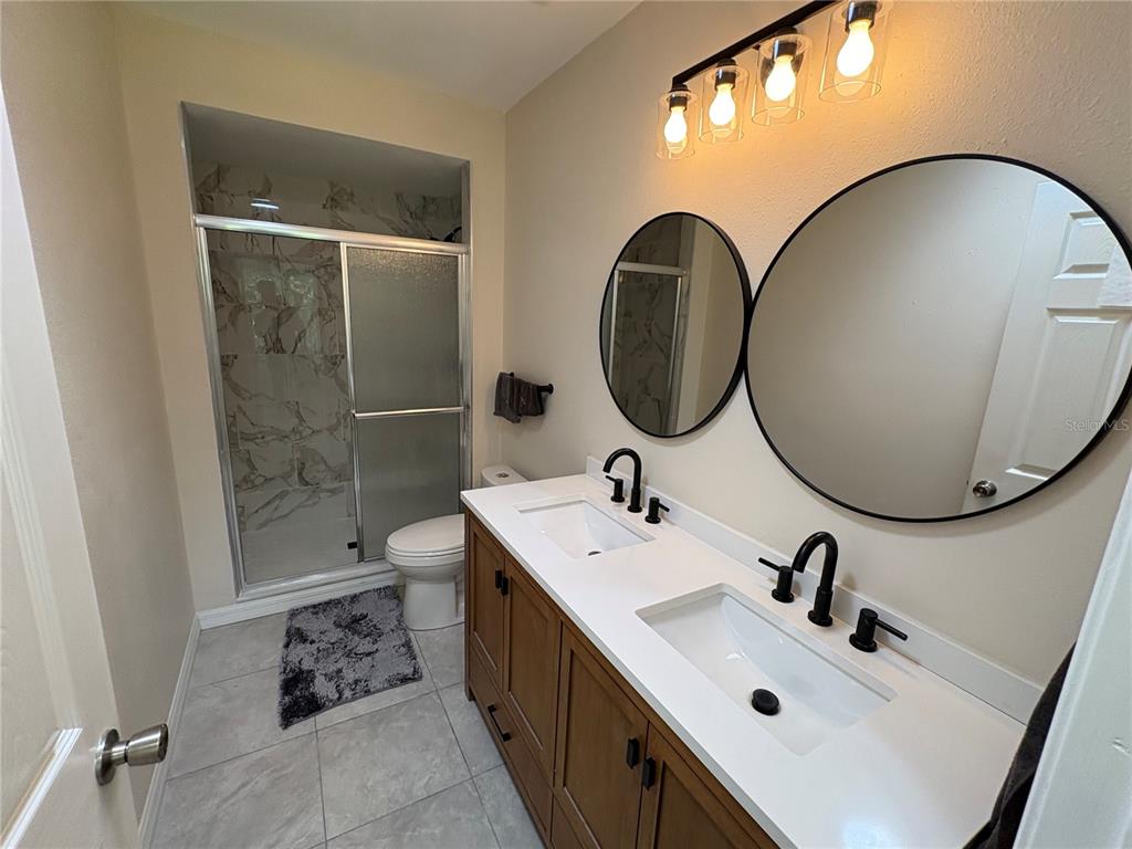 2110 Northwest 100th Street Ocala, FL 34475 - Photo 23 of 44 a bathroom with a sink and mirror