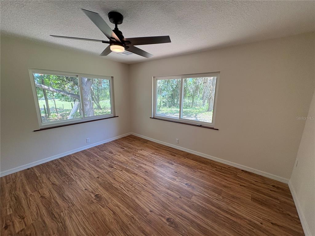 2110 Northwest 100th Street Ocala, FL 34475 - Photo 25 of 44 a view of an empty room with wooden floor and a window