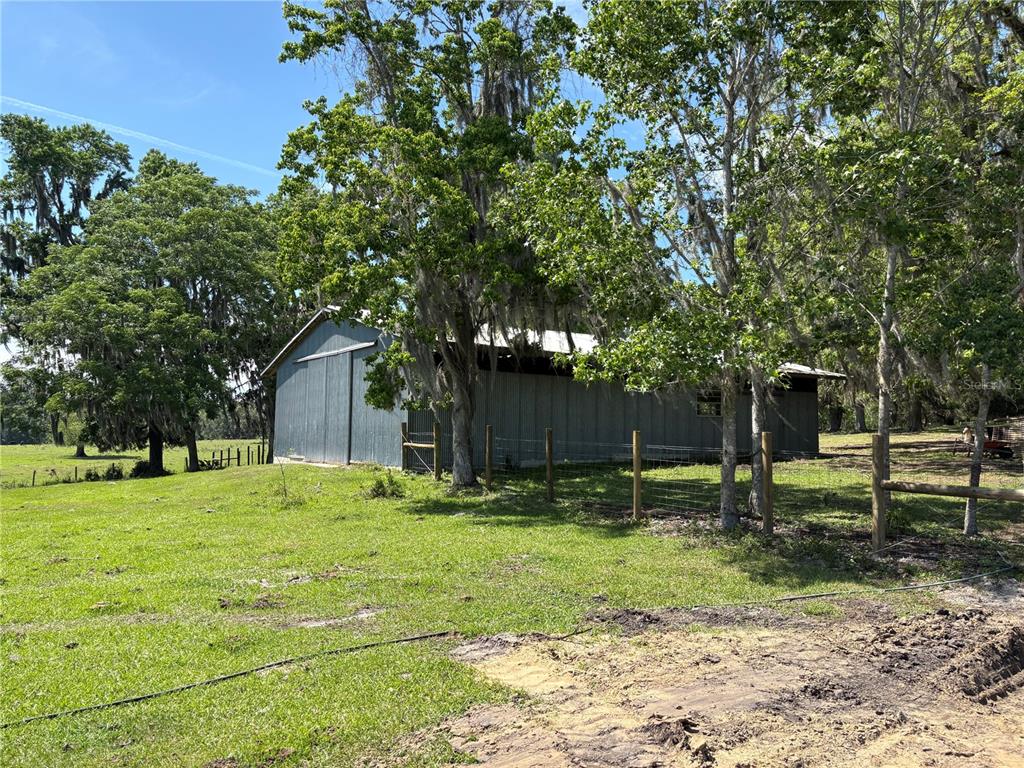 2110 Northwest 100th Street Ocala, FL 34475 - Photo 27 of 44 a backyard of a house with lots of green space and fountain