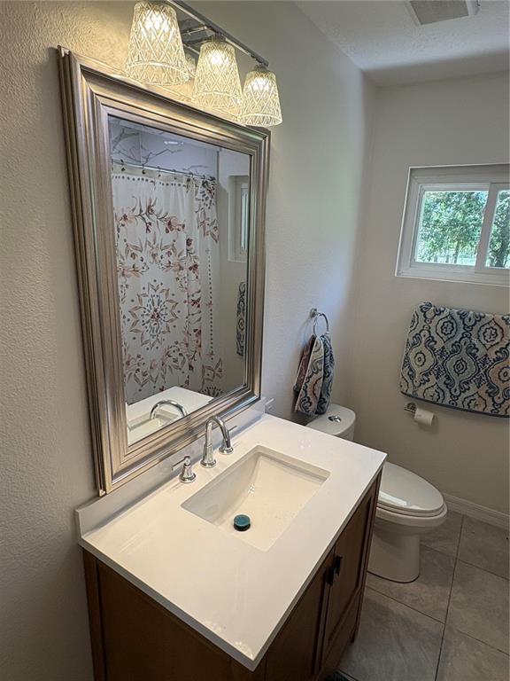 2110 Northwest 100th Street Ocala, FL 34475 - Photo 28 of 42 a bathroom with a sink a toilet and mirror