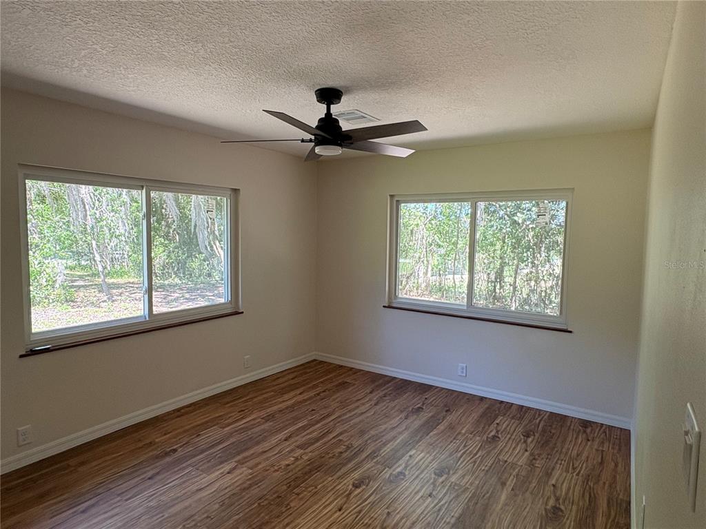 2110 Northwest 100th Street Ocala, FL 34475 - Photo 29 of 44 a view of an empty room with a window and wooden floor
