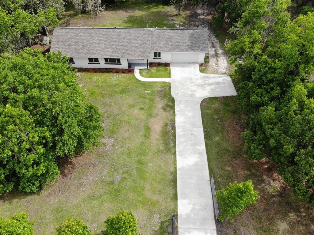 2110 Northwest 100th Street Ocala, FL 34475 - Photo 4 of 44 an aerial view of a house with yard swimming pool and outdoor seating