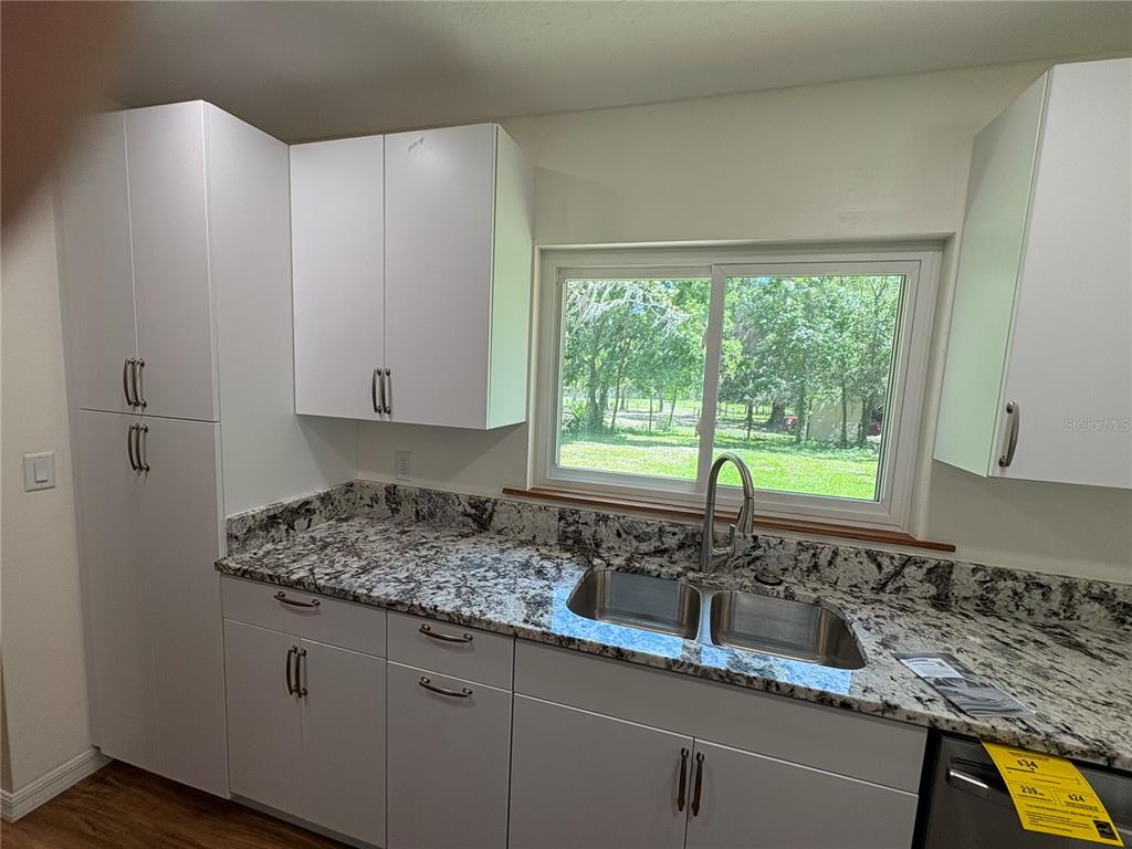 2110 Northwest 100th Street Ocala, FL 34475 - Photo 7 of 44 a kitchen with a sink and a window