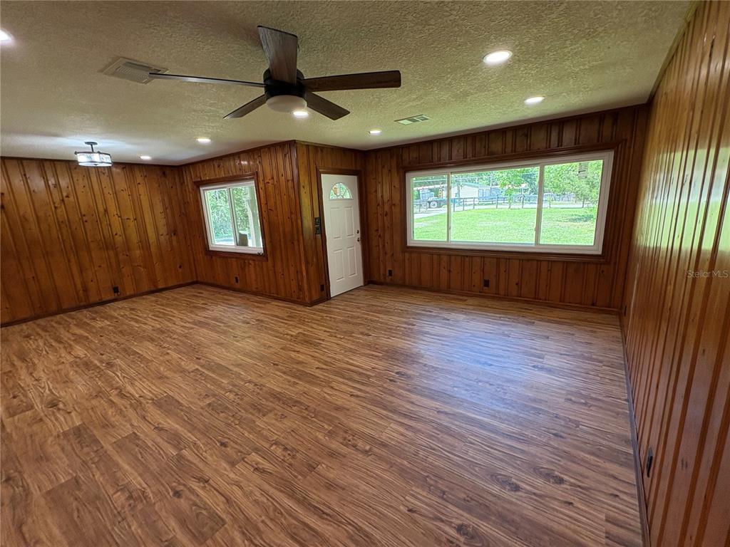 2110 Northwest 100th Street Ocala, FL 34475 - Photo 10 of 44 a view of an empty room with a window and wooden floor
