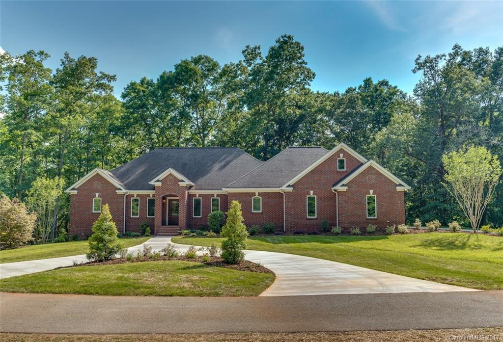 1322 Baber Road Rutherfordton, NC 28139 - Photo 1 of 24 a front view of a house with a garden and trees