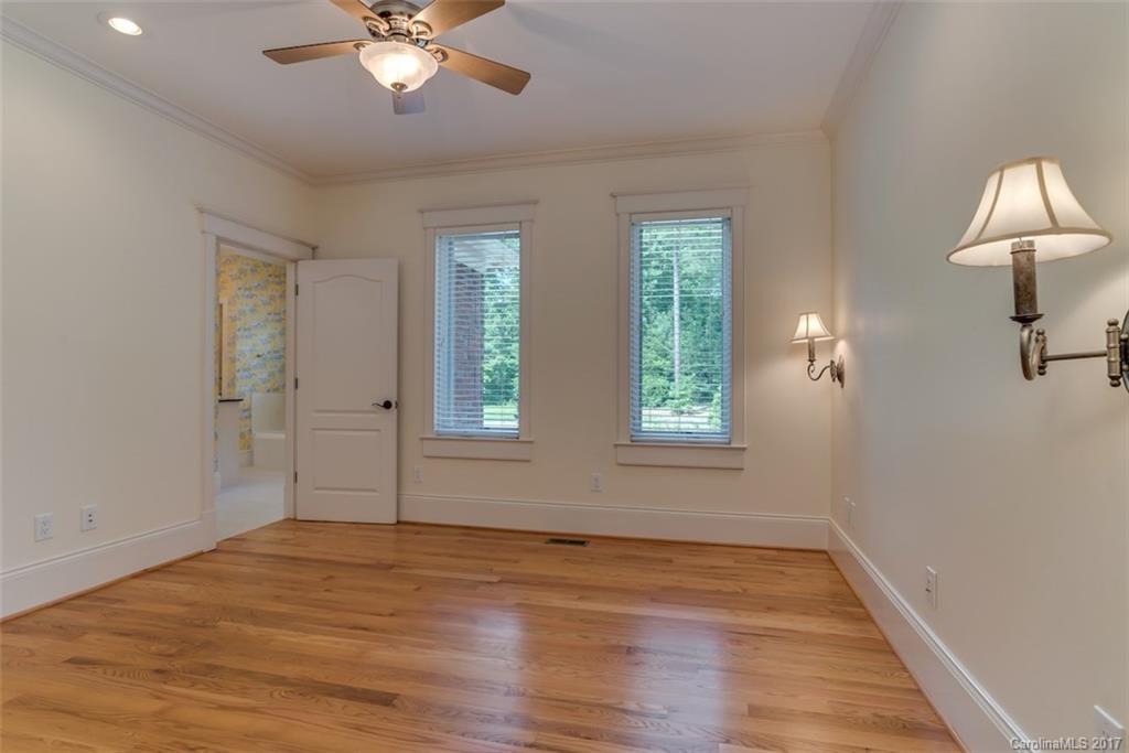 1322 Baber Road Rutherfordton, NC 28139 - Photo 13 of 24 an empty room with wooden floor fan and windows