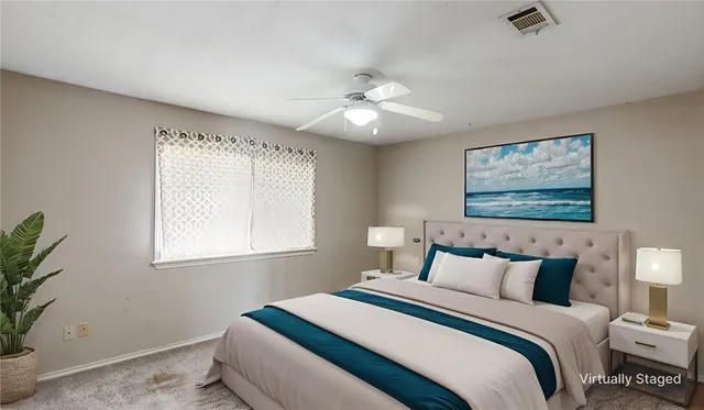 a bedroom with a bed and a painting on the wall