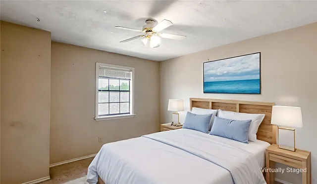 a bedroom with a large bed and a chandelier