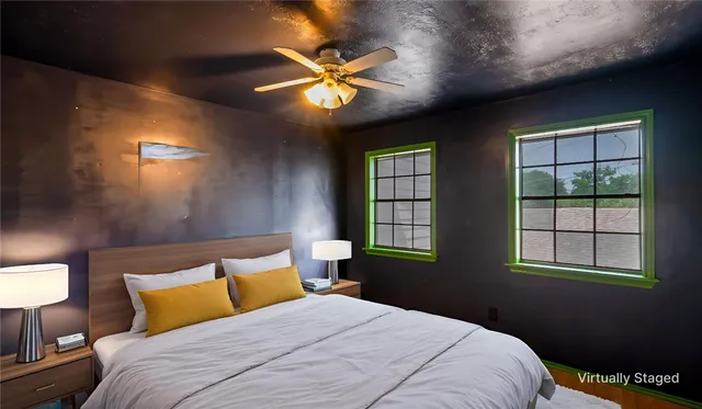 a bedroom with a bed and a window