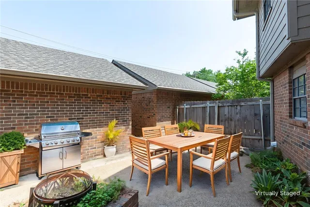 a backyard of a house with table and chairs