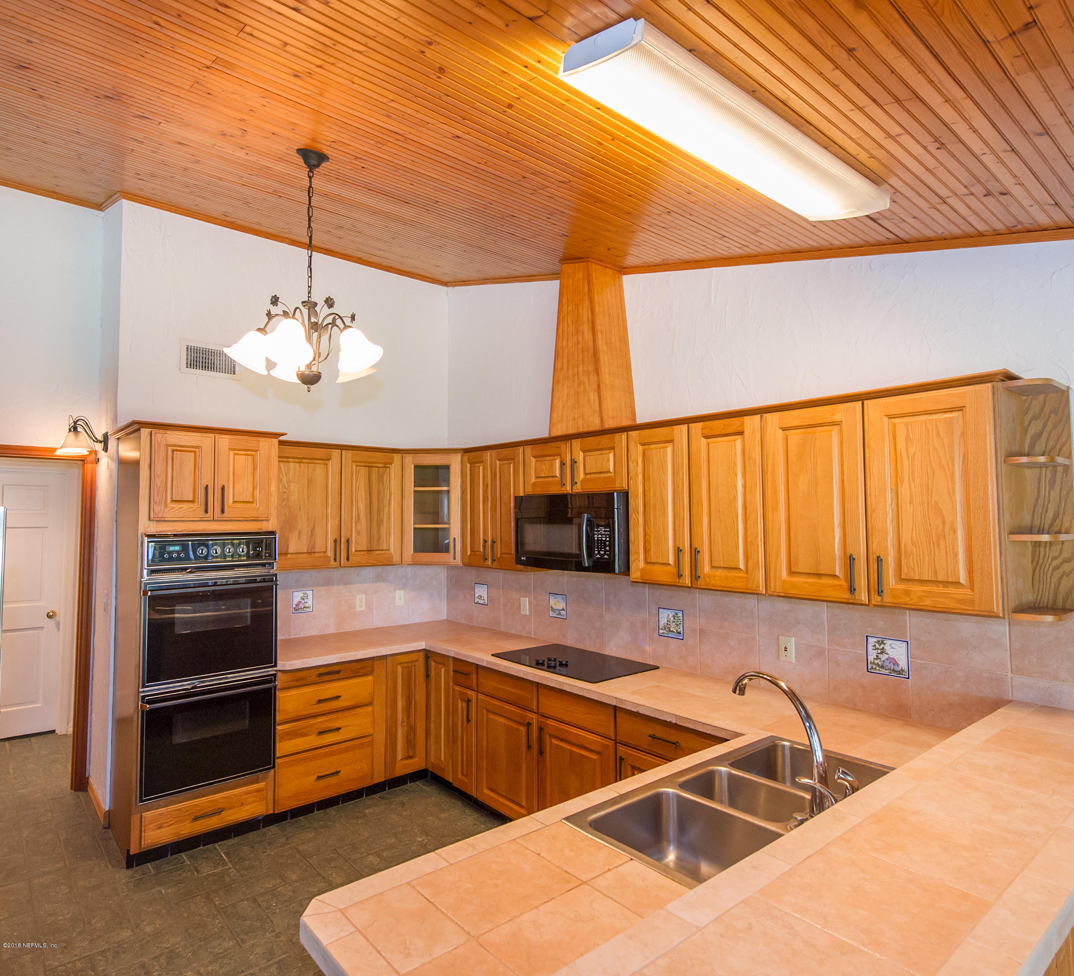 524 Vaill Point Road St. Augustine, FL 32086 - Photo 20 of 50 a kitchen with stainless steel appliances kitchen island granite countertop a sink and cabinets
