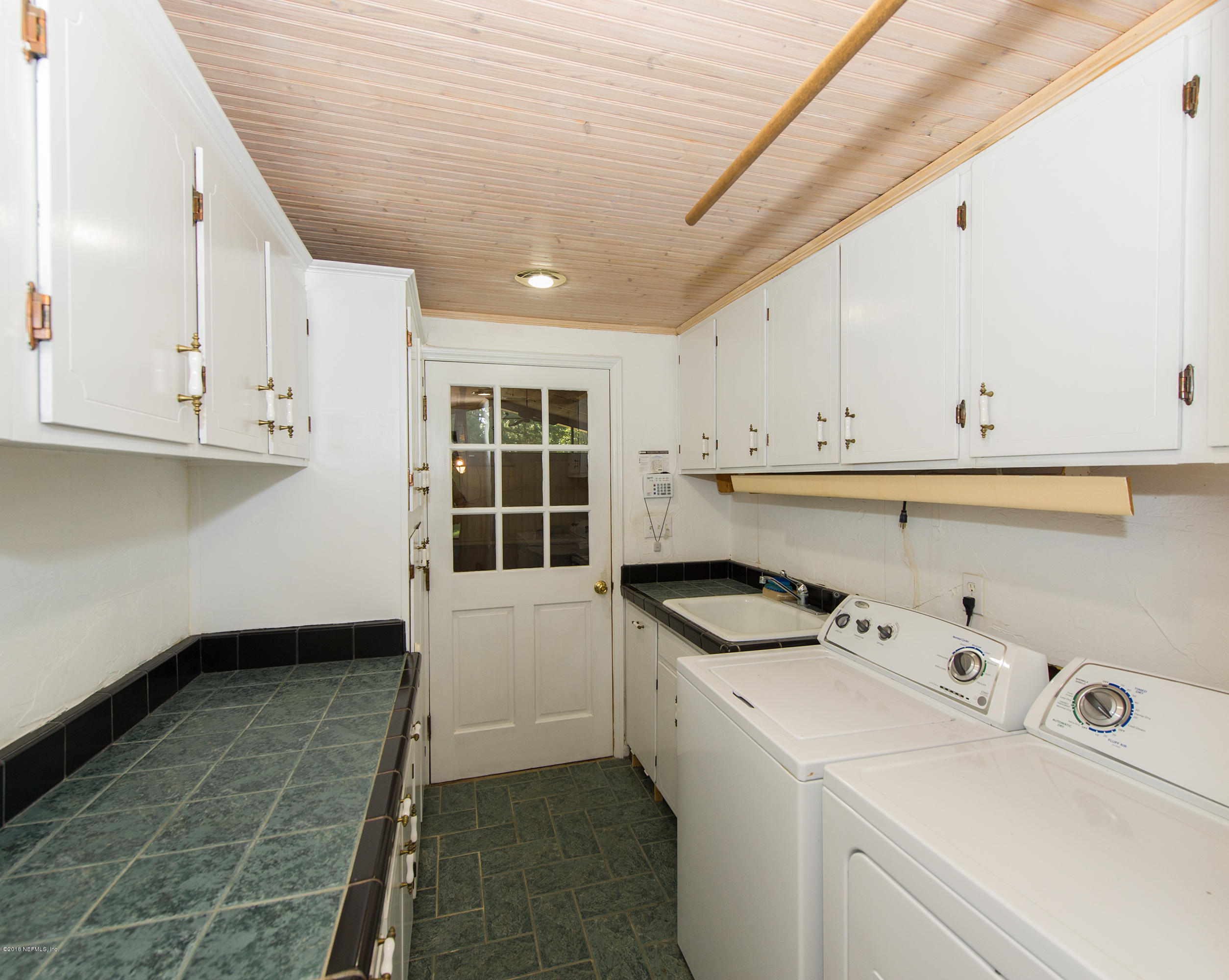 524 Vaill Point Road St. Augustine, FL 32086 - Photo 30 of 50 a kitchen with a cabinets and white appliances