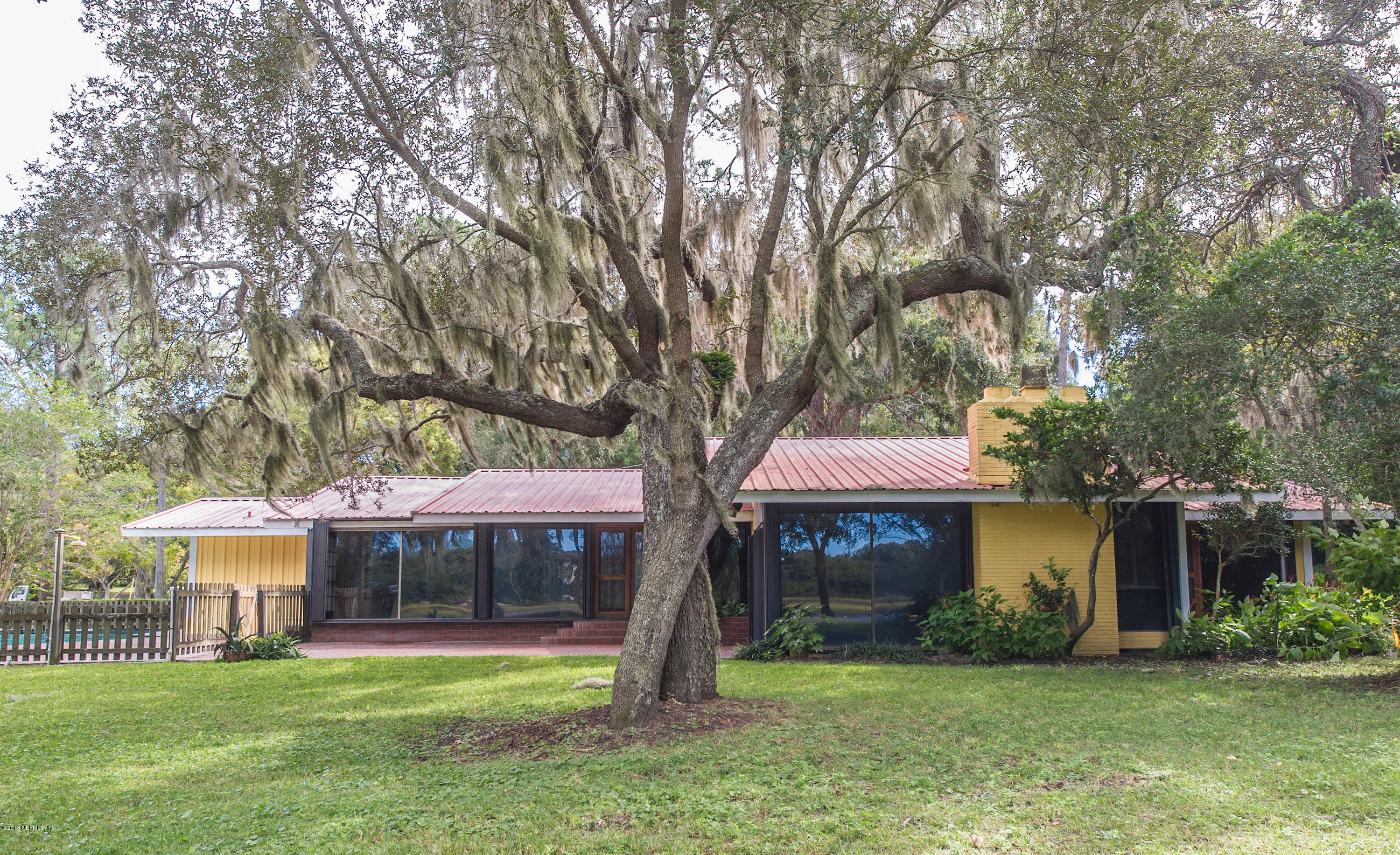 524 Vaill Point Road St. Augustine, FL 32086 - Photo 43 of 50 a front view of a house with a garden and trees