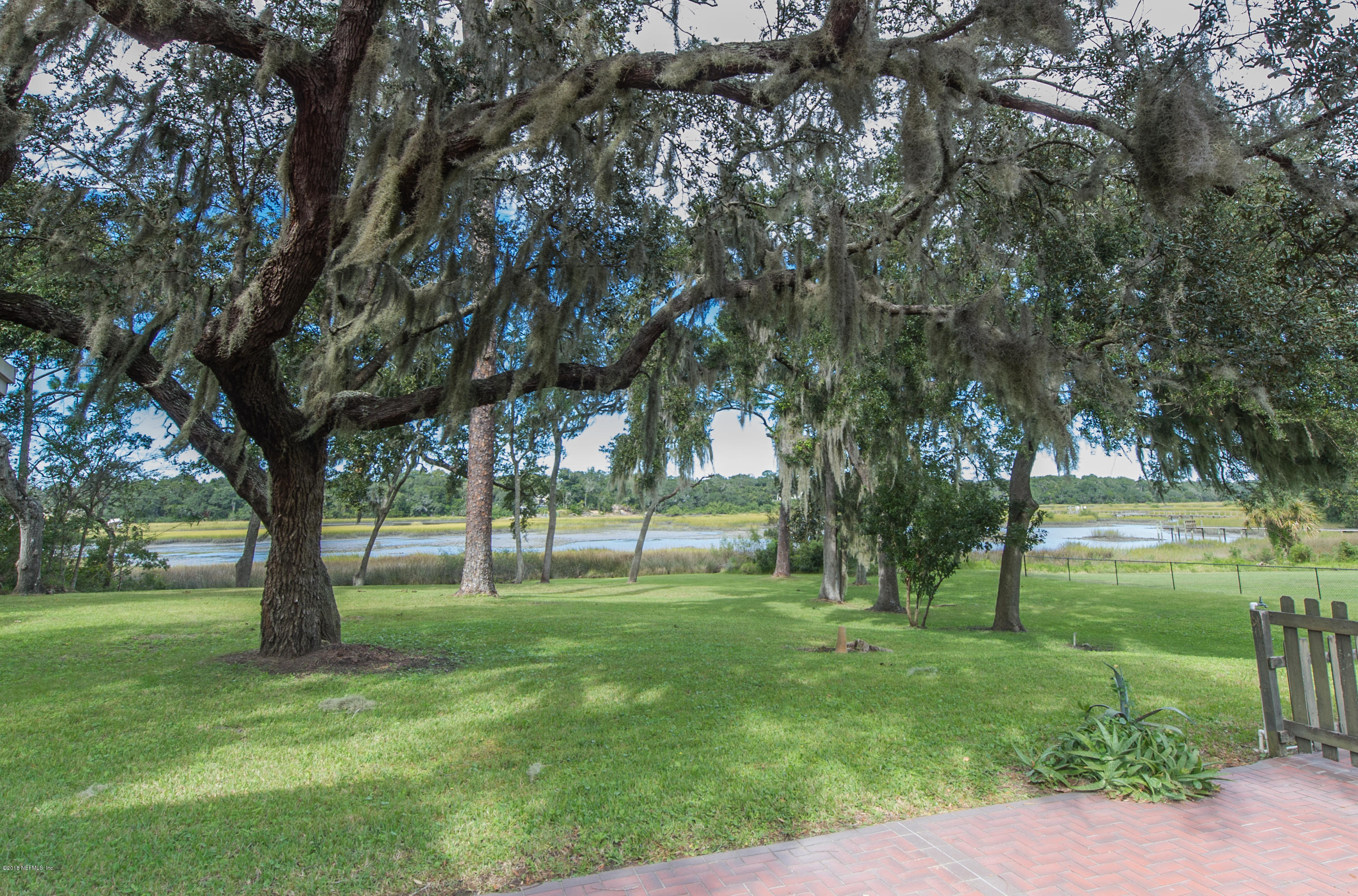 524 Vaill Point Road St. Augustine, FL 32086 - Photo 45 of 50 a view of grassy field with benches and trees