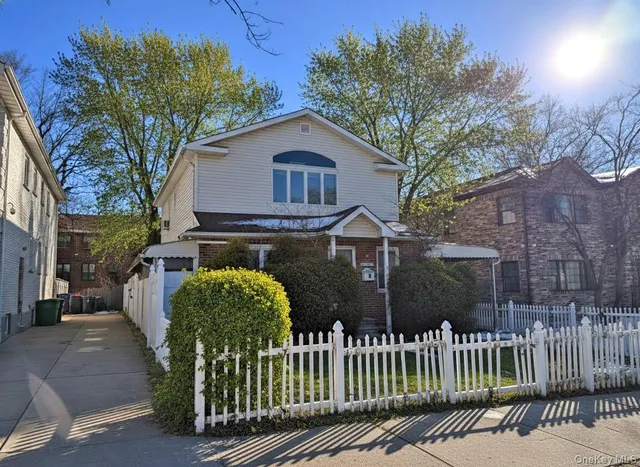 a front view of a house with a garden