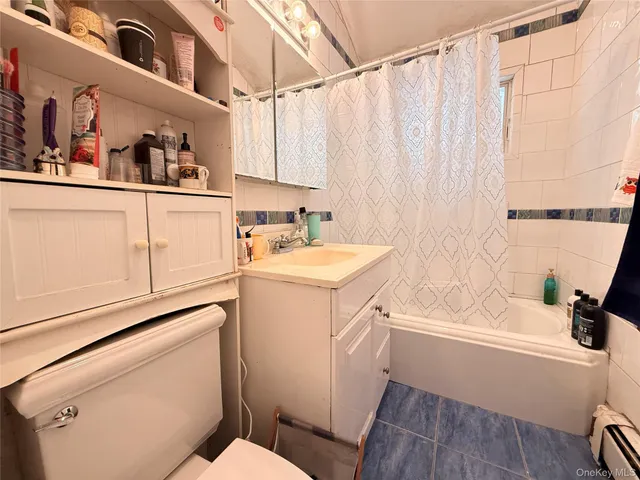 a bathroom with a sink a toilet and bathtub