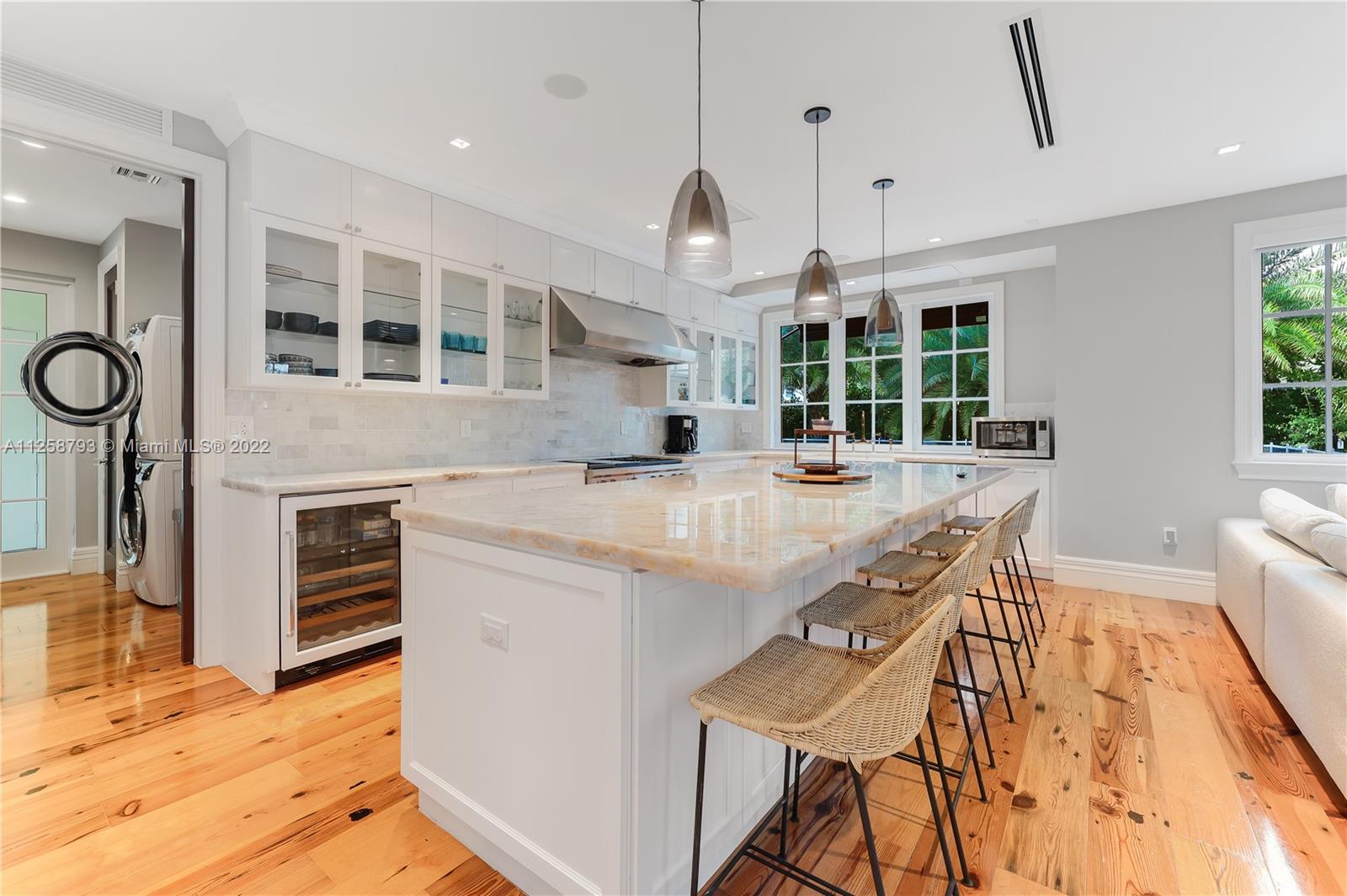 1311 Alhambra Circle Miami, FL 33134 - Photo 15 of 56 a kitchen with stainless steel appliances kitchen island granite countertop a stove and a large window