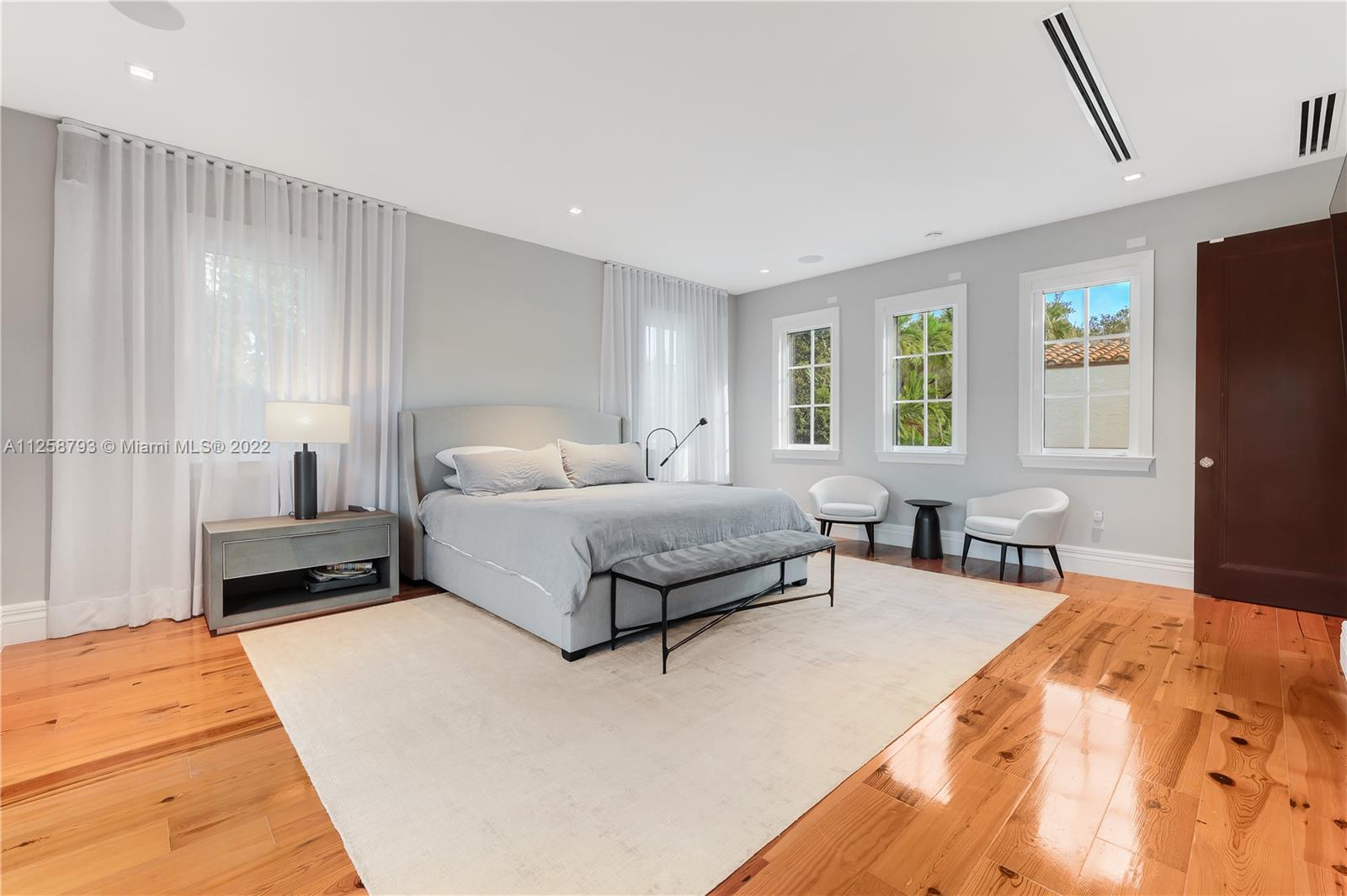 1311 Alhambra Circle Miami, FL 33134 - Photo 37 of 56 a bedroom with a bed and wooden floor