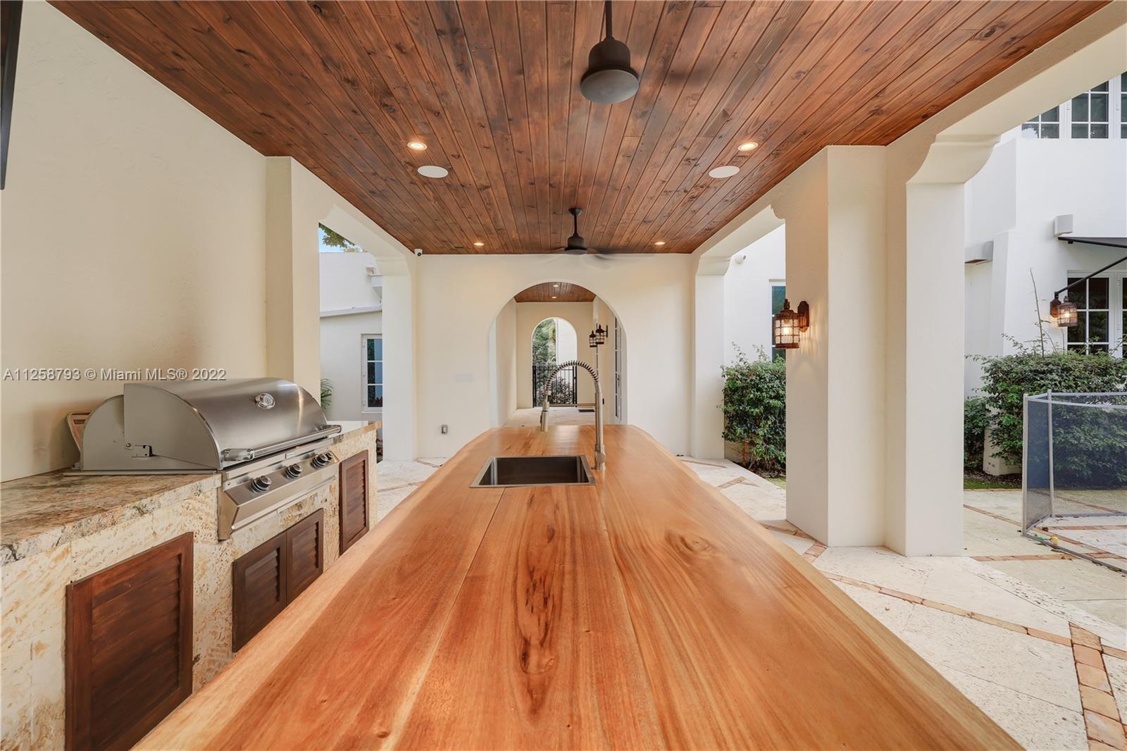 1311 Alhambra Circle Miami, FL 33134 - Photo 40 of 56 a view of a kitchen with a sink wooden floor and staircase