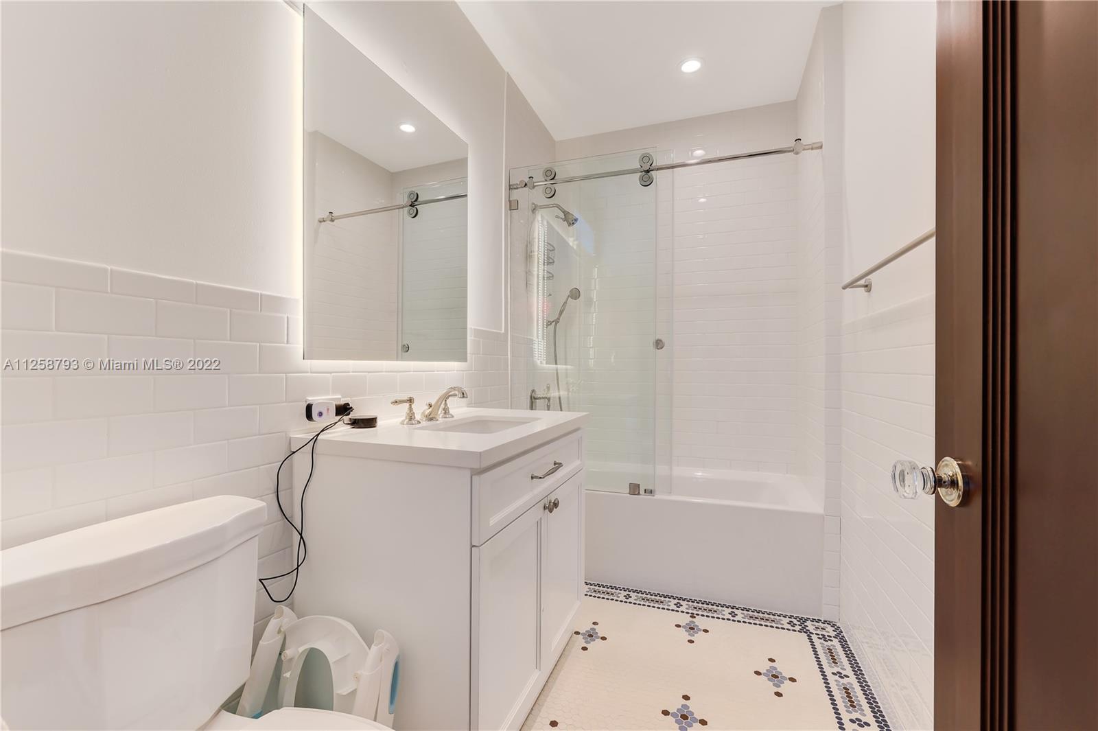 1311 Alhambra Circle Miami, FL 33134 - Photo 49 of 56 a bathroom with a sink a toilet and shower