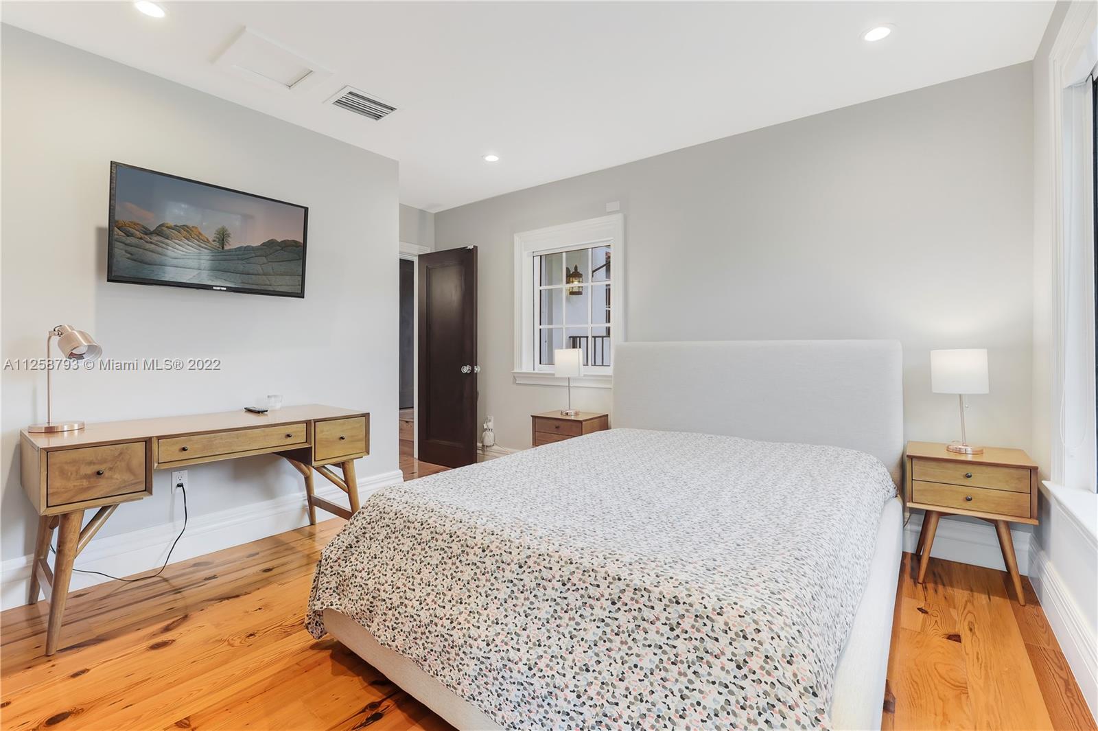 1311 Alhambra Circle Miami, FL 33134 - Photo 50 of 56 a bedroom with a bed and a flat screen tv