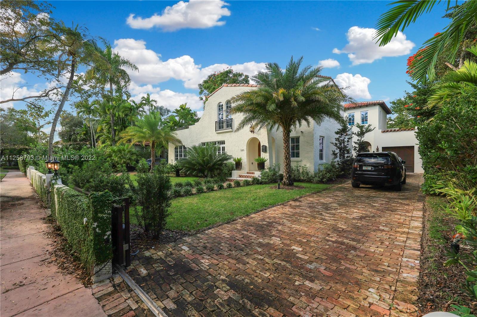 1311 Alhambra Circle Miami, FL 33134 - Photo 5 of 56 a palm tree sitting in front of a house with a garden