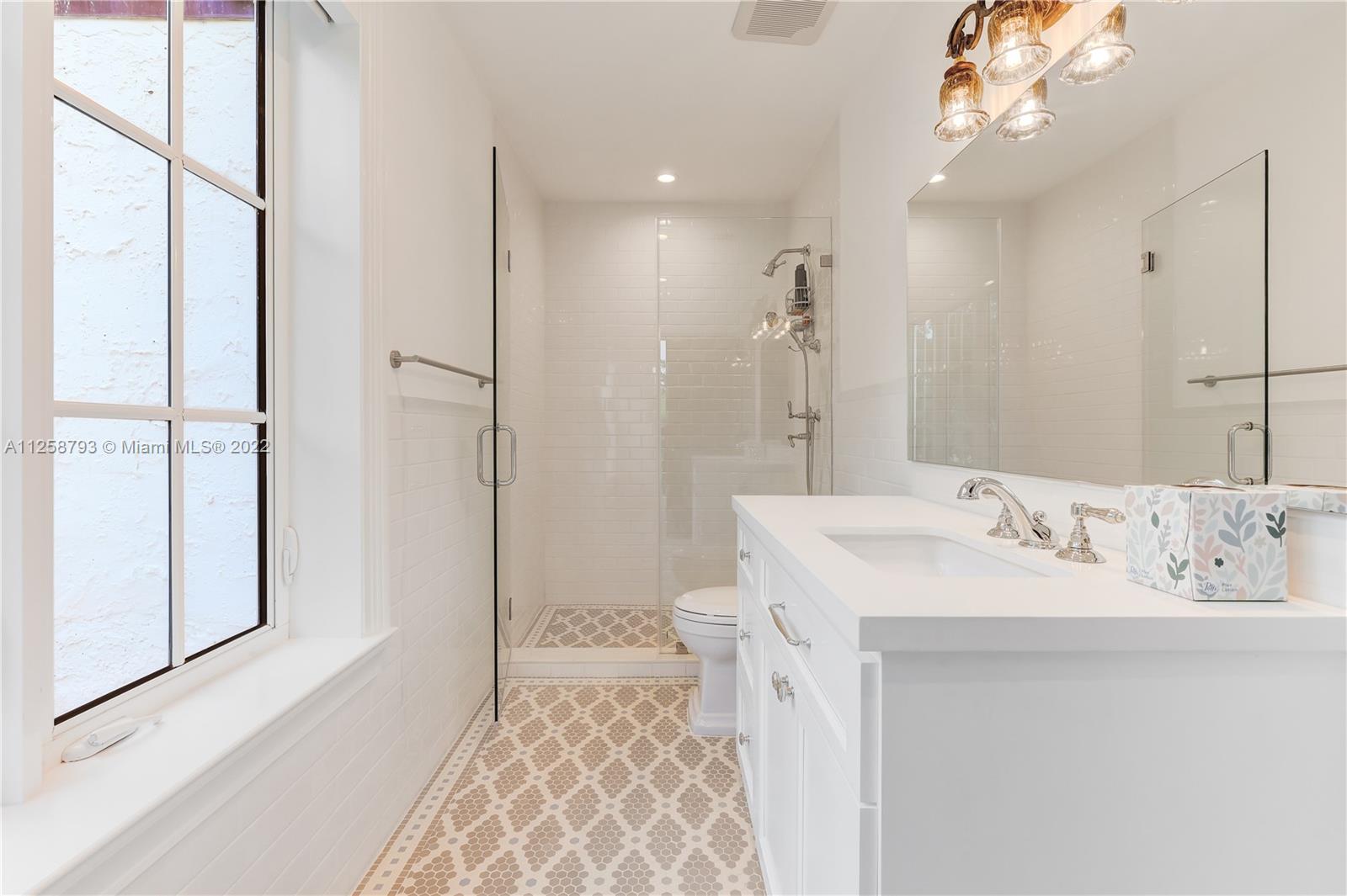 1311 Alhambra Circle Miami, FL 33134 - Photo 51 of 56 a spacious bathroom with a sink a mirror and a shower