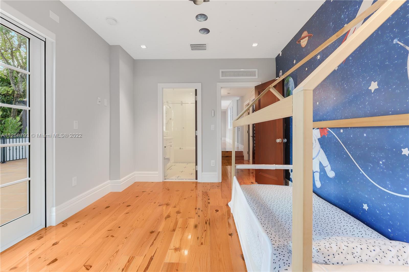 1311 Alhambra Circle Miami, FL 33134 - Photo 53 of 56 a bedroom with a bed and a flat screen tv