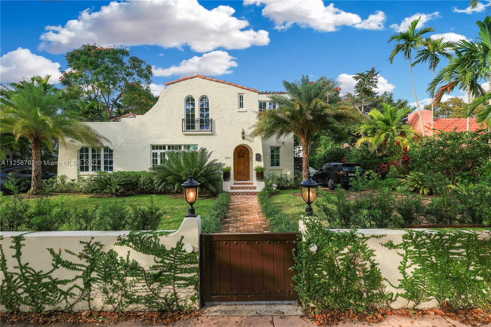 1311 Alhambra Circle Miami, FL 33134 - Photo 6 of 56 a front view of a house with a yard