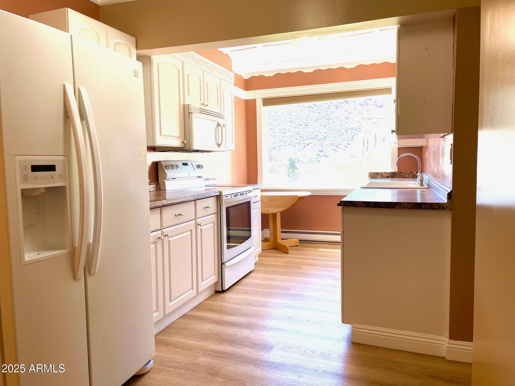220 A Opera Drive Bisbee, AZ 85603 - Photo 15 of 46 a kitchen with stainless steel appliances a sink a stove and a refrigerator