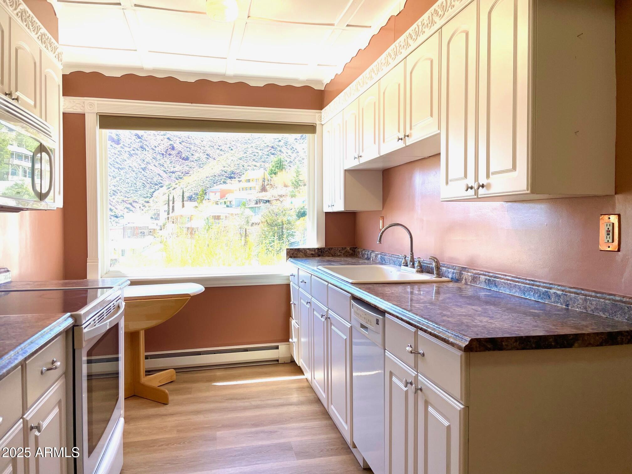 220 A Opera Drive Bisbee, AZ 85603 - Photo 16 of 46 a kitchen with kitchen island granite countertop a sink and a stove