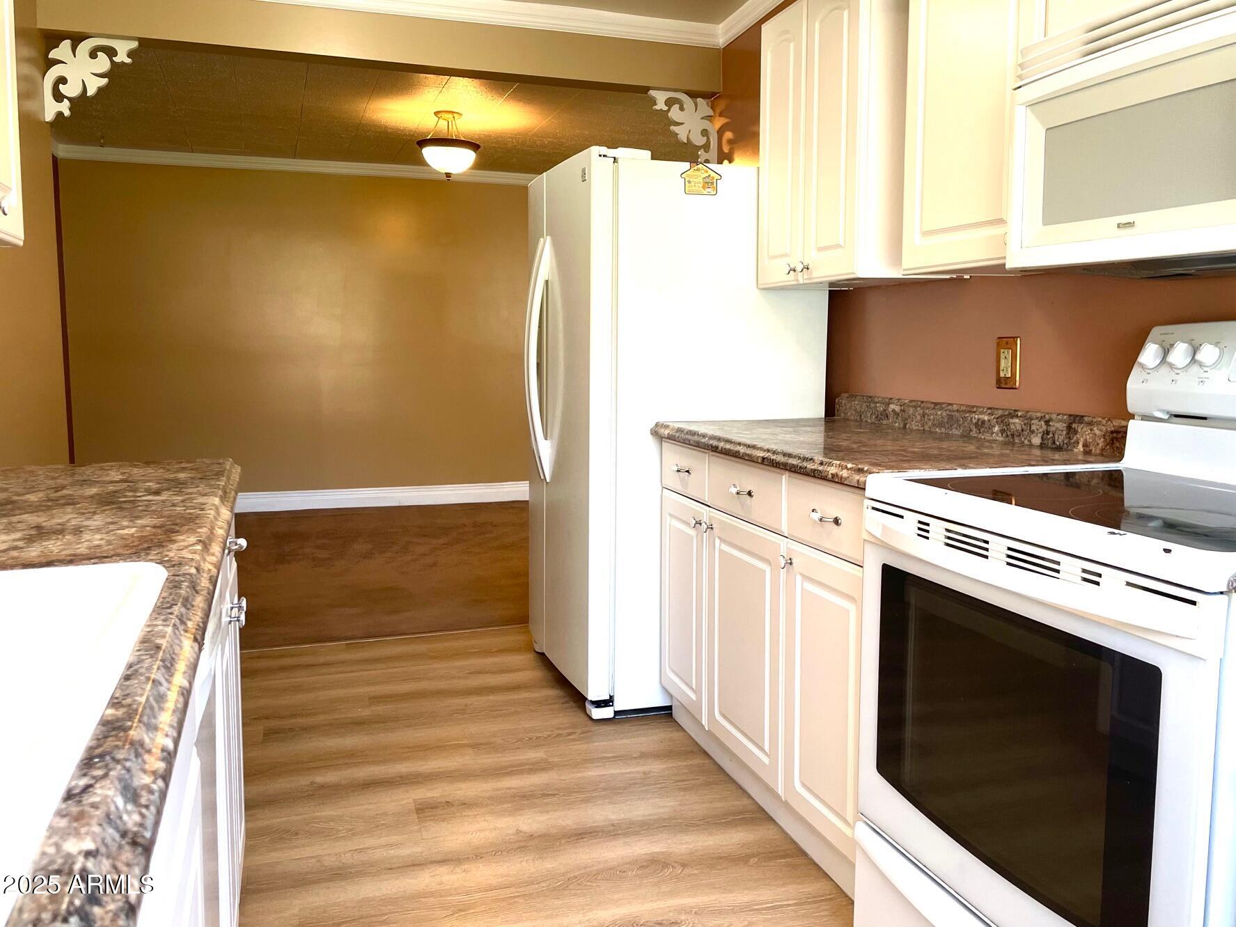 220 A Opera Drive Bisbee, AZ 85603 - Photo 17 of 46 a kitchen with a stove and a refrigerator