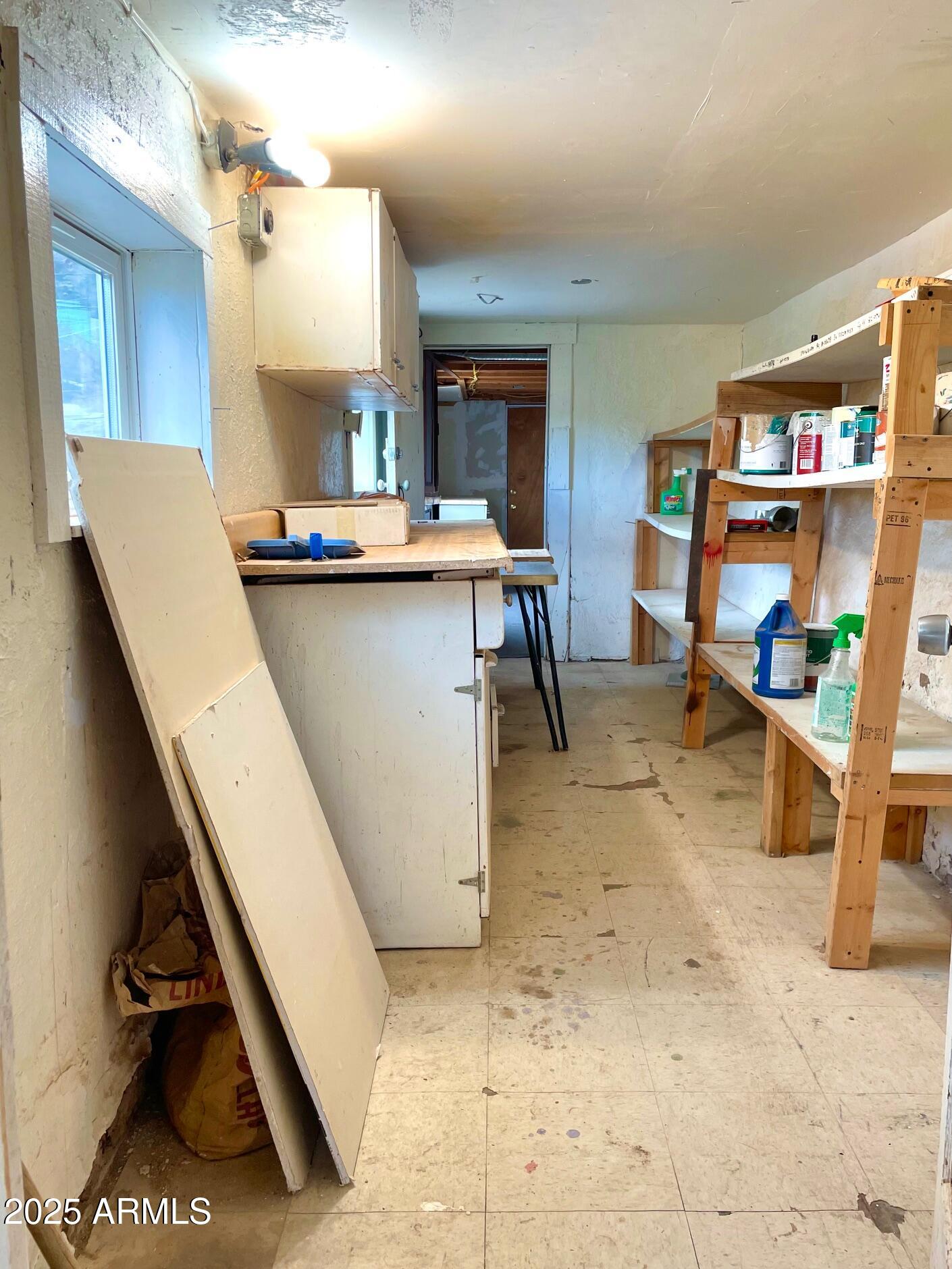 220 A Opera Drive Bisbee, AZ 85603 - Photo 43 of 46 a living room with stainless steel appliances furniture a rug and a large window