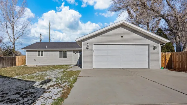 a view of a house with a yard and garage