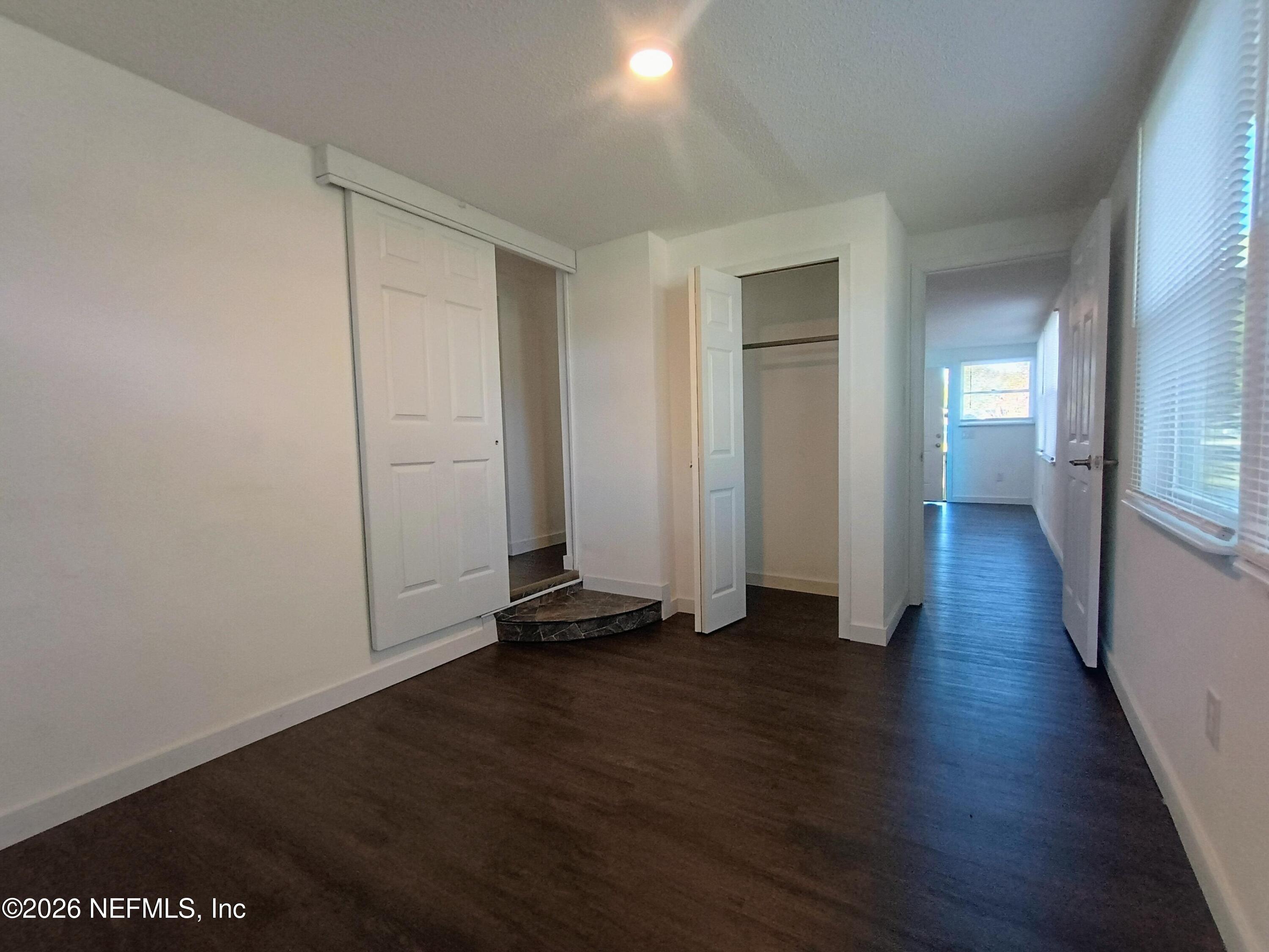 215 Pine Tree Trail Crescent City, FL 32112 - Photo 12 of 25 a view of a room with wooden floor and closet