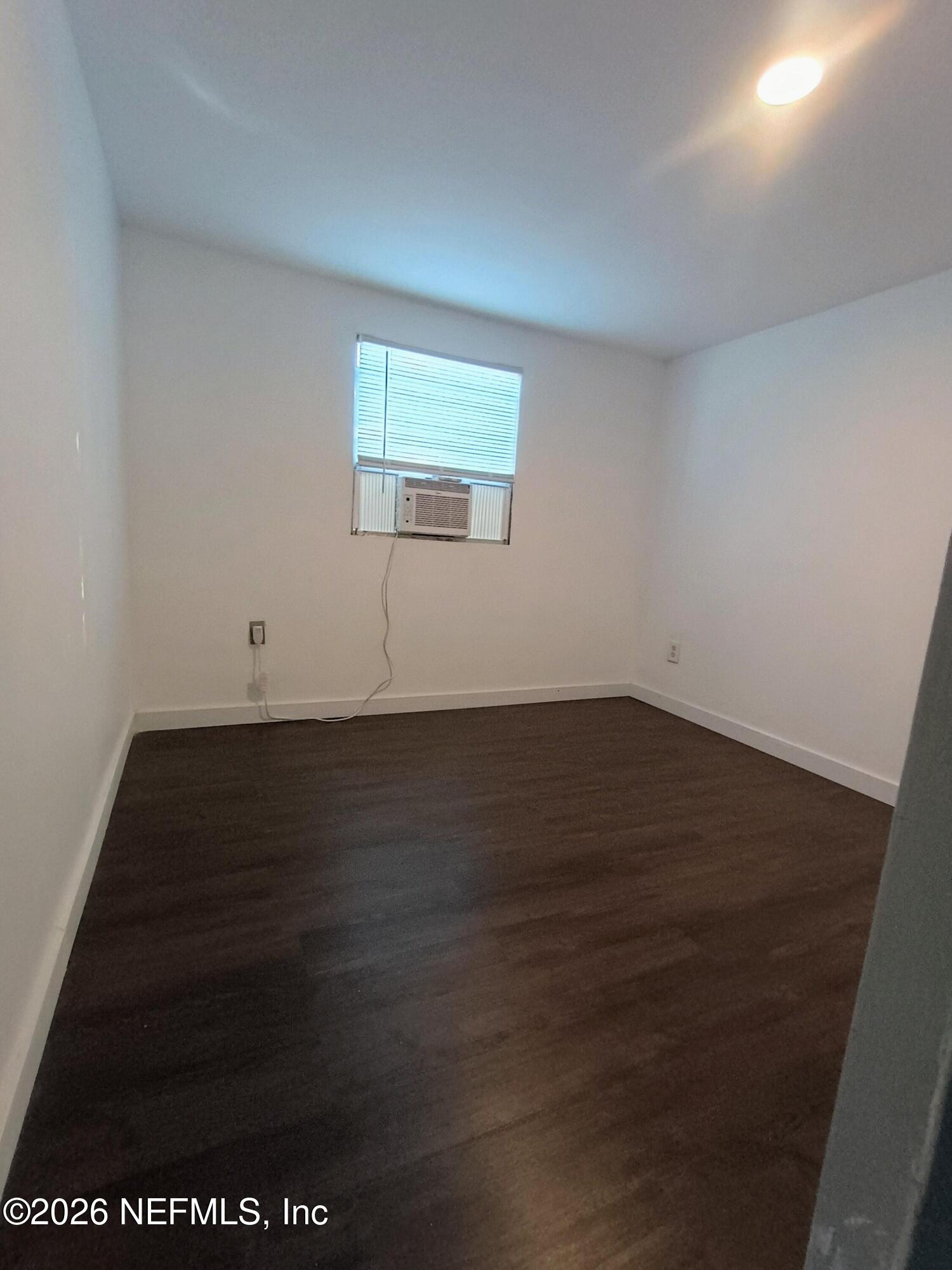 215 Pine Tree Trail Crescent City, FL 32112 - Photo 13 of 25 an empty room with wooden floor and windows