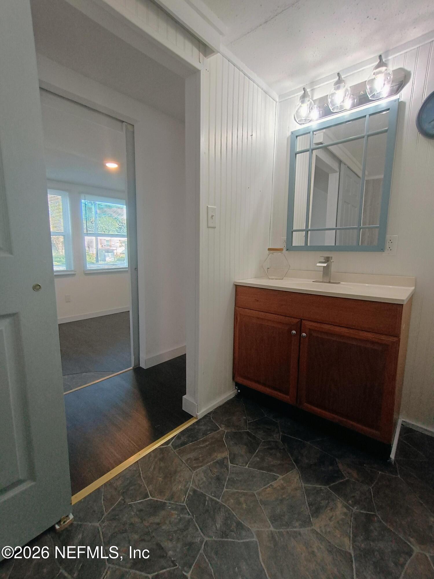 215 Pine Tree Trail Crescent City, FL 32112 - Photo 14 of 25 a bathroom with a sink a mirror and a shower