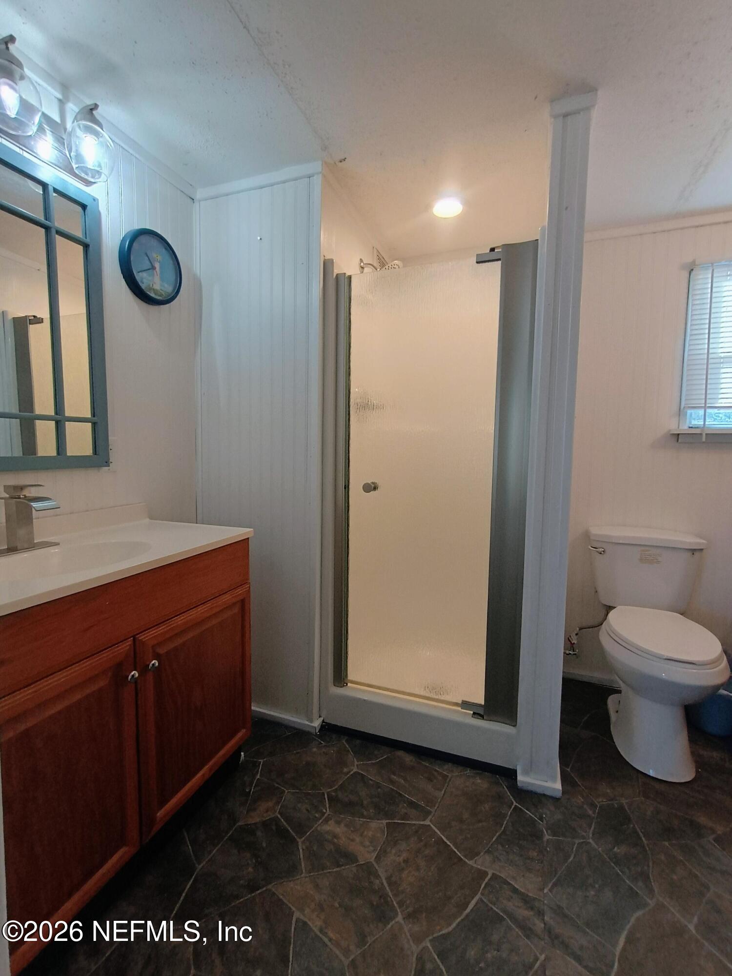 215 Pine Tree Trail Crescent City, FL 32112 - Photo 15 of 25 a bathroom with a sink a toilet and a mirror