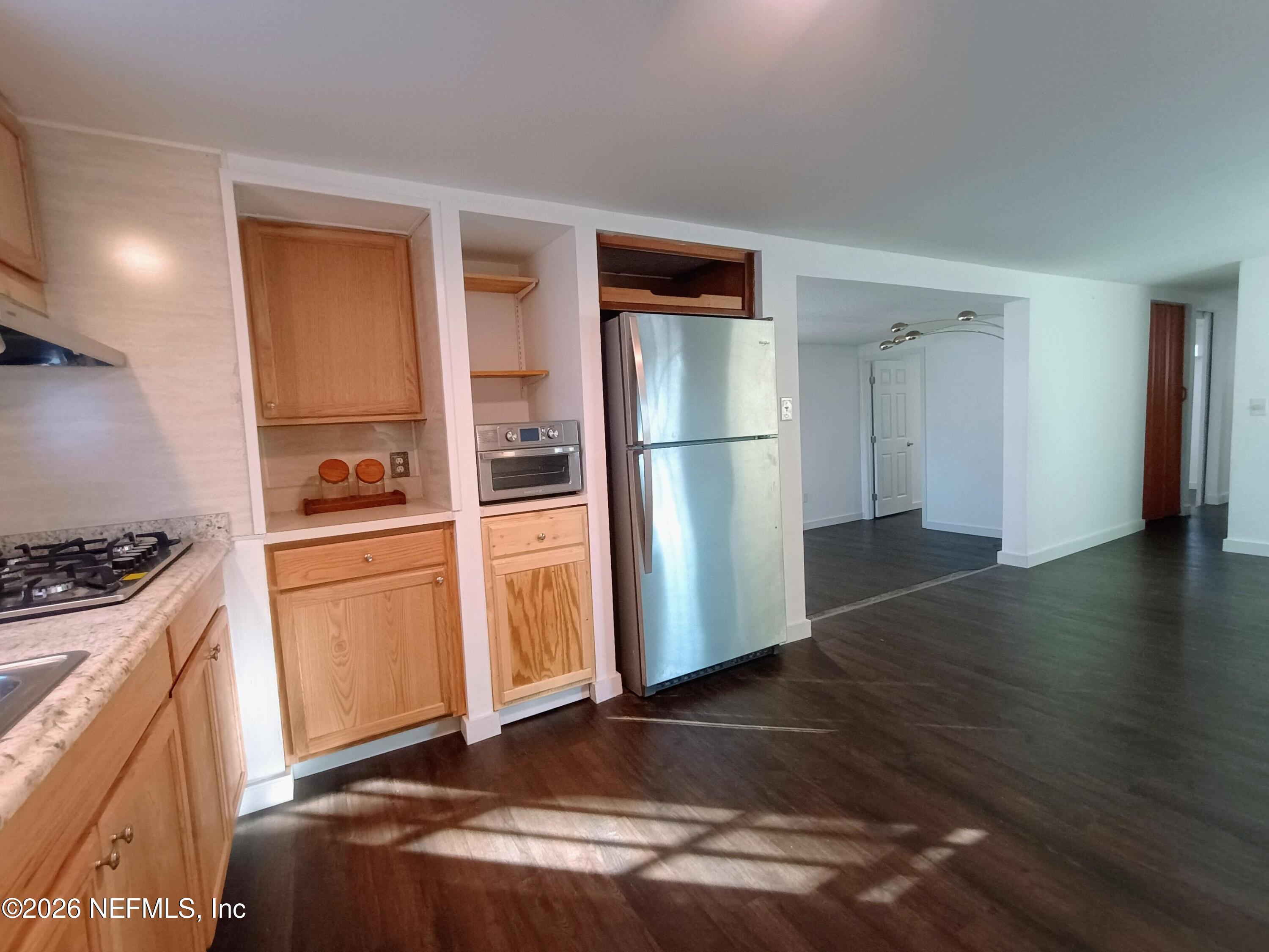 215 Pine Tree Trail Crescent City, FL 32112 - Photo 17 of 25 a kitchen with a refrigerator and a stove top oven