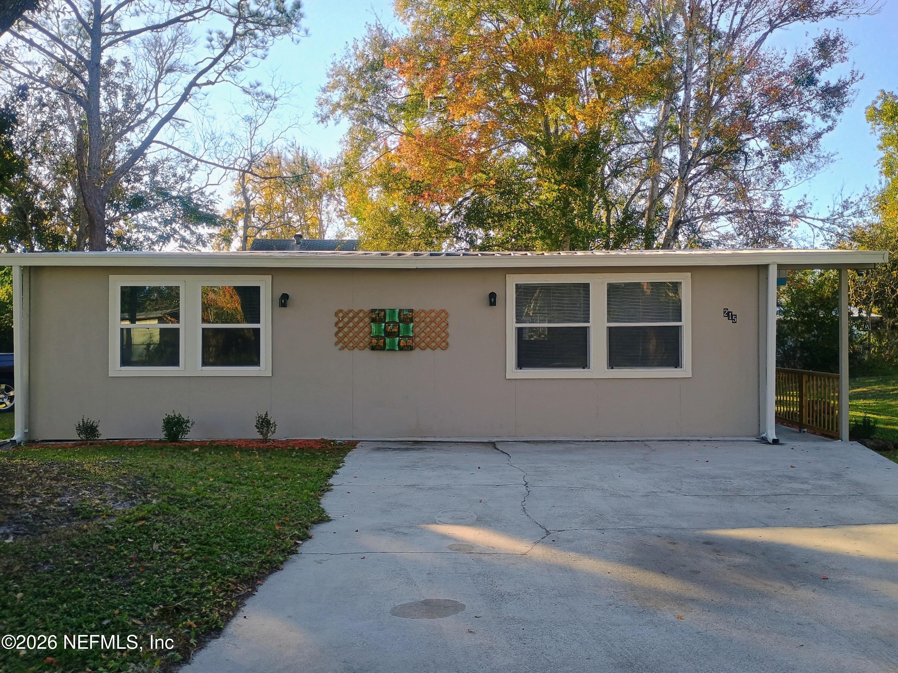 215 Pine Tree Trail Crescent City, FL 32112 - Photo 2 of 25 a house view with a garden space