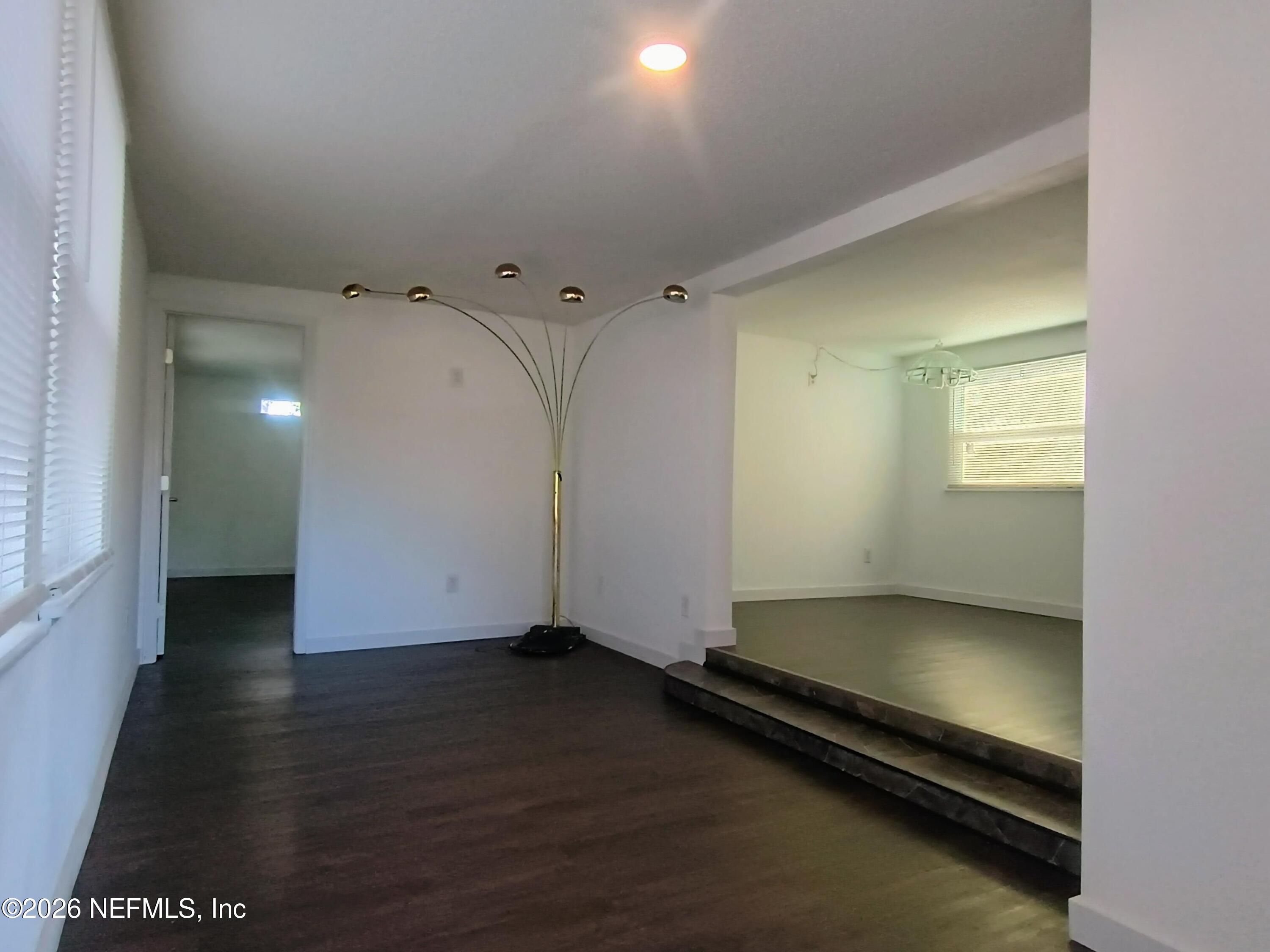 215 Pine Tree Trail Crescent City, FL 32112 - Photo 7 of 25 an empty room with wooden floor and windows