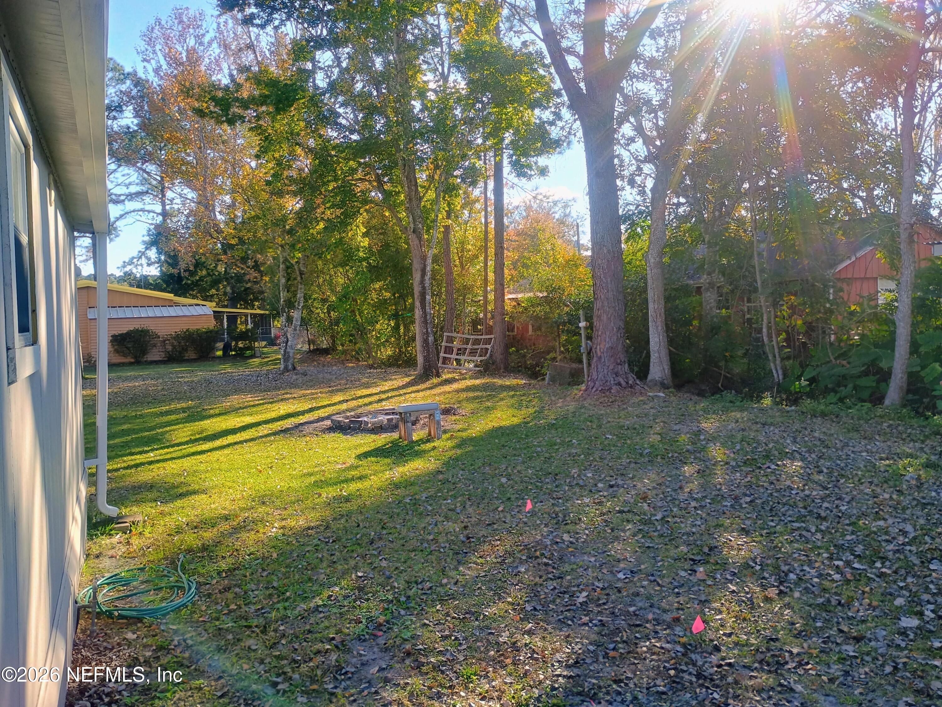 215 Pine Tree Trail Crescent City, FL 32112 - Photo 10 of 25 a view of swimming pool with large trees and a big yard