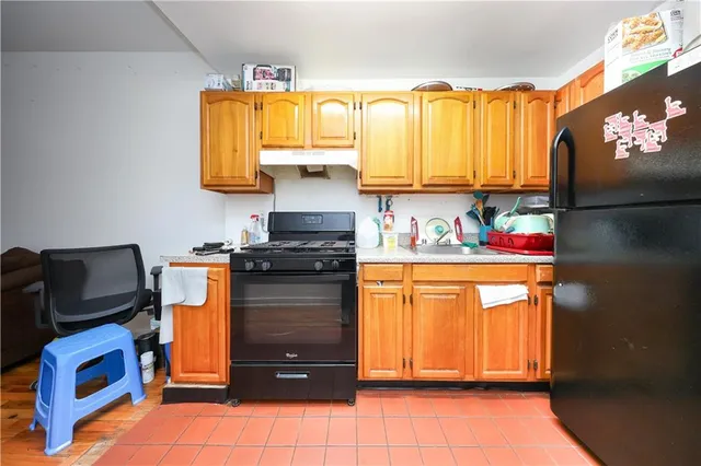 a kitchen with stainless steel appliances granite countertop a refrigerator and a stove