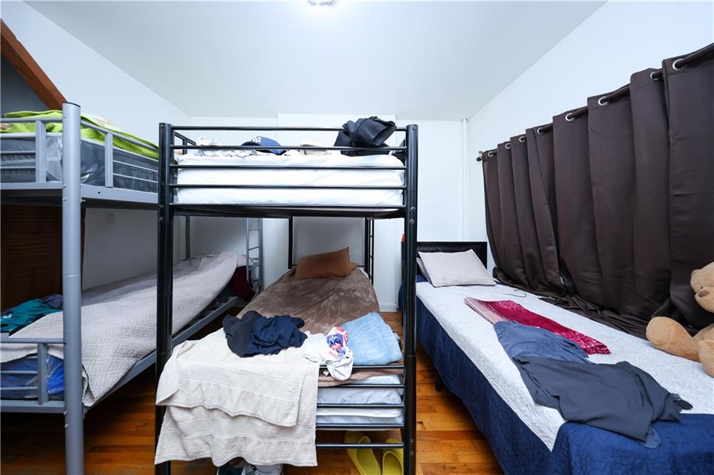 5813 4th Avenue Brooklyn, NY 11220 - Photo 9 of 25 a living room with furniture and wooden floor