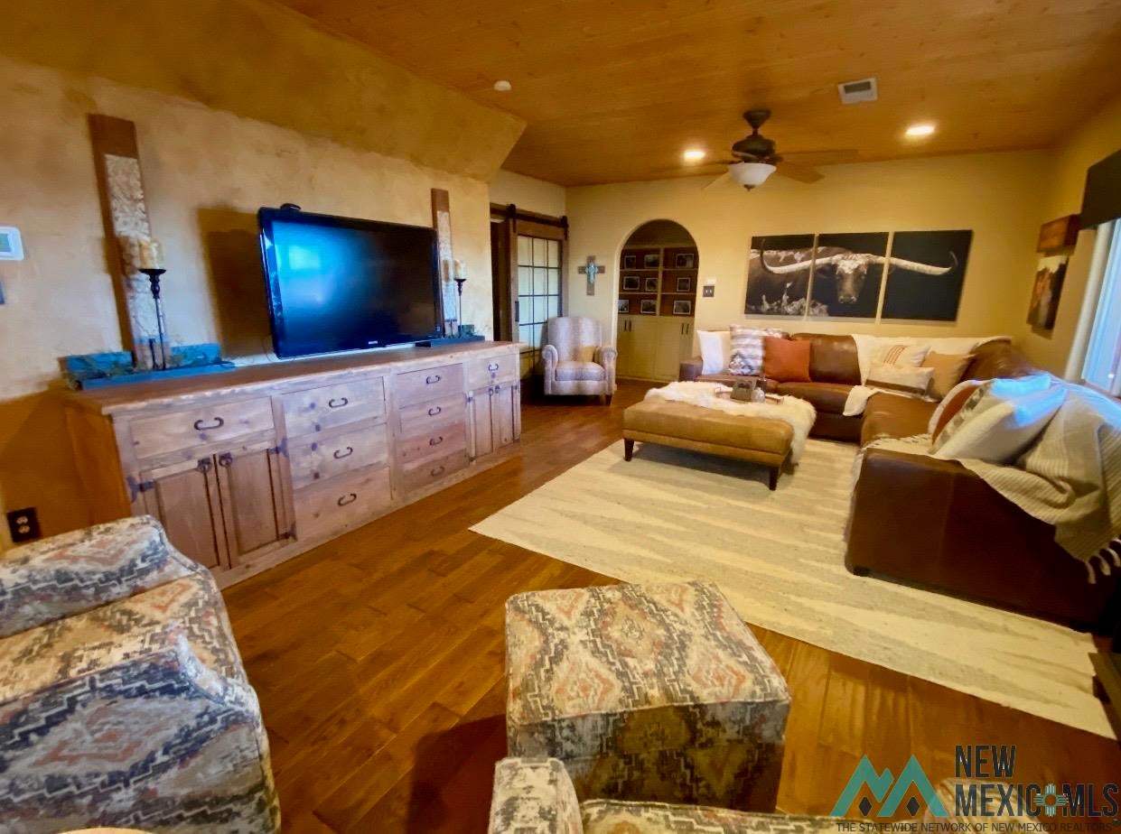 1131 Curry Road North Clovis, NM 88101 - Photo 12 of 69 Spacious living area featuring wood-finish flooring, a wood plank ceiling, and recessed lighting