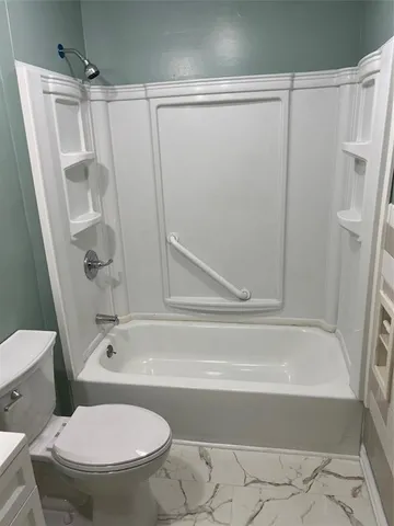 a bathroom with a toilet and a shower