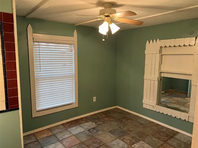 a view of a livingroom with a chandelier fan and a fireplace