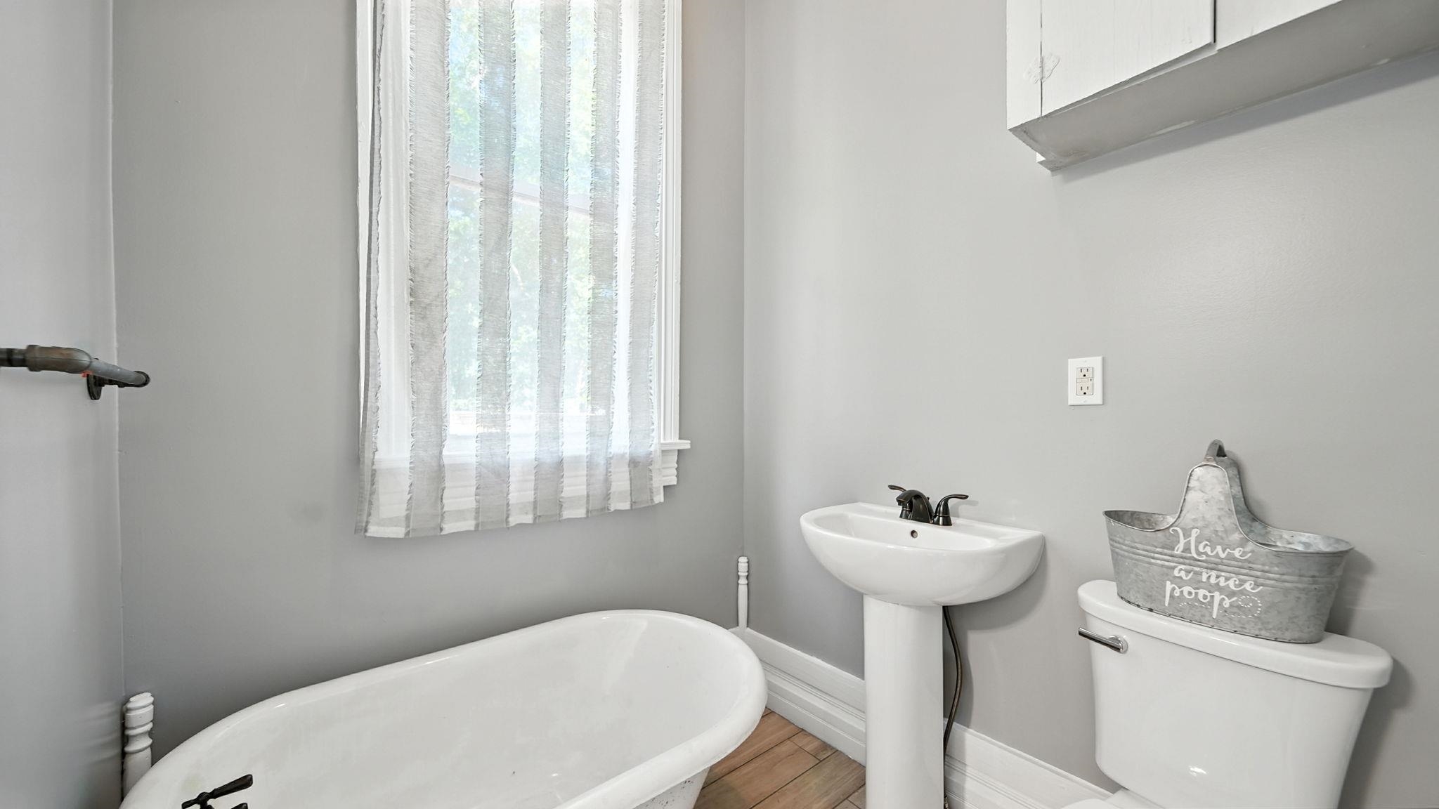 320 North Maple Street Covington, TN 38019 - Photo 20 of 35 Full bath featuring a freestanding tub, healthy amount of natural light, and wood finished floors