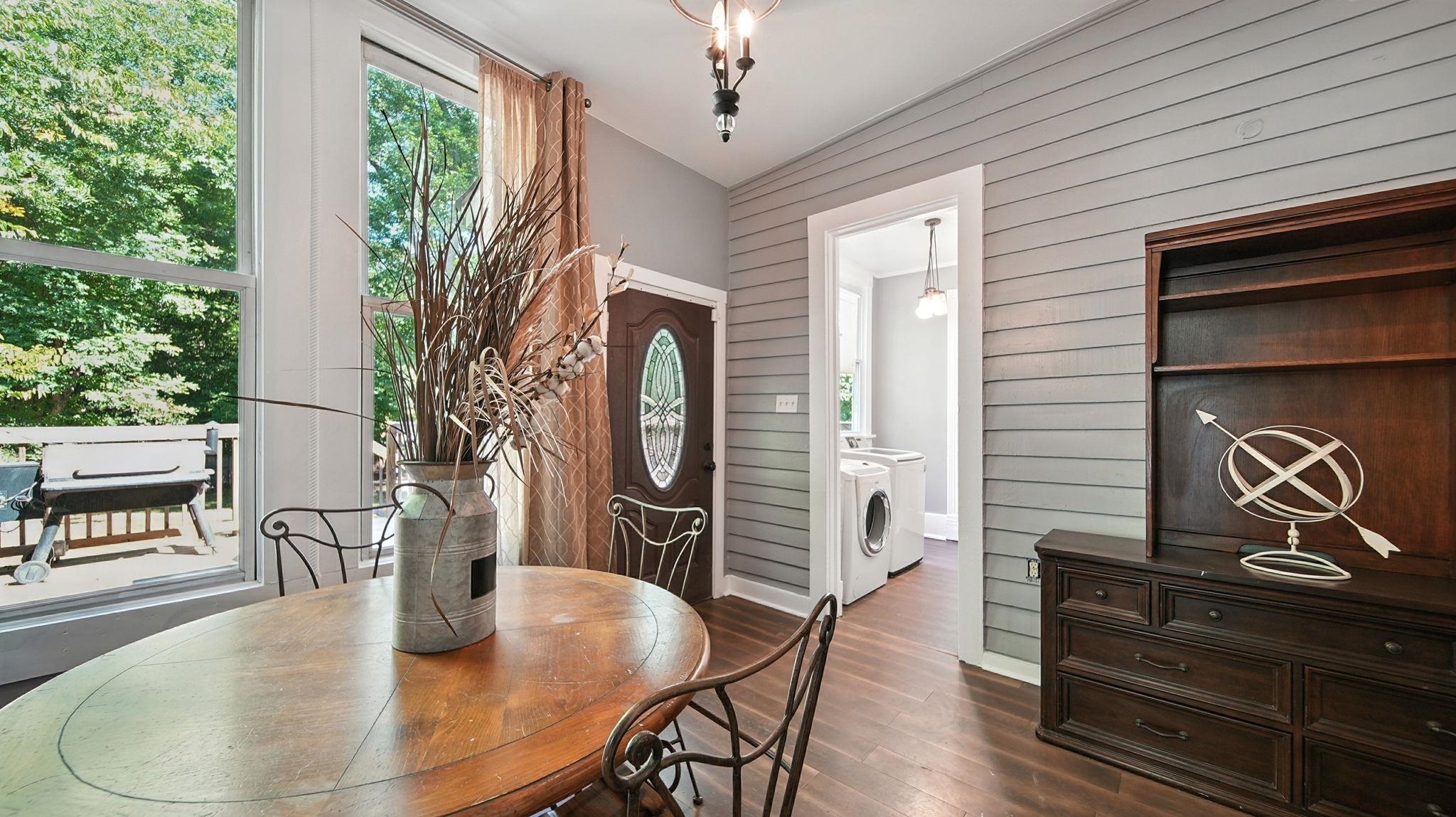 320 North Maple Street Covington, TN 38019 - Photo 23 of 35 Dining area featuring dark wood finished floors, wood walls, and washer / dryer